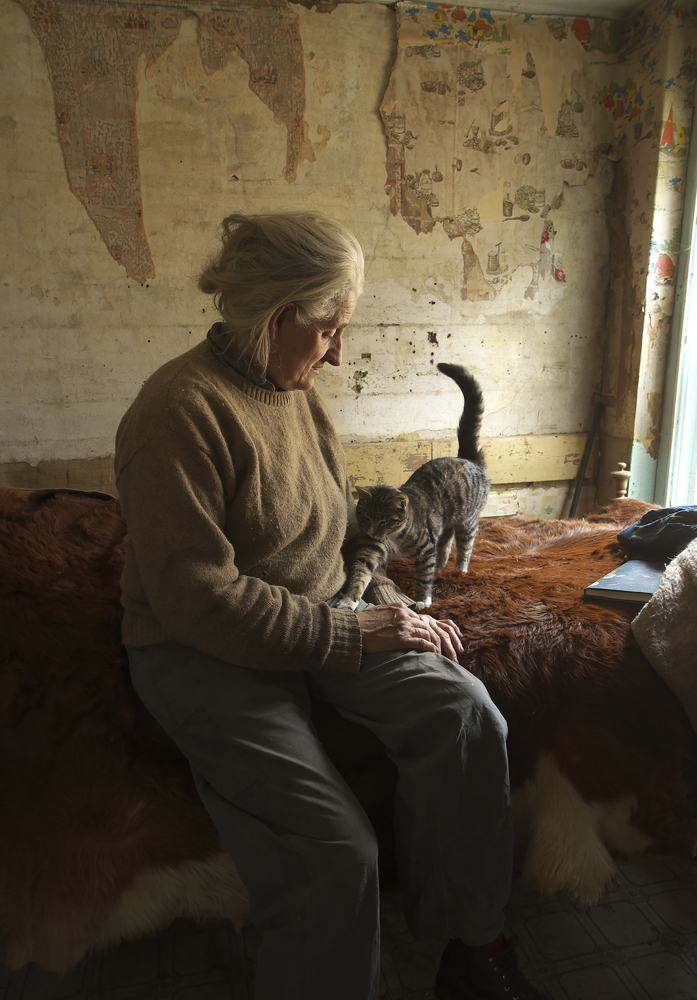 woman farmer, farm cat, rustic living, simple life, rural, old farmhouse, torn wallpaper, Vershire, VT