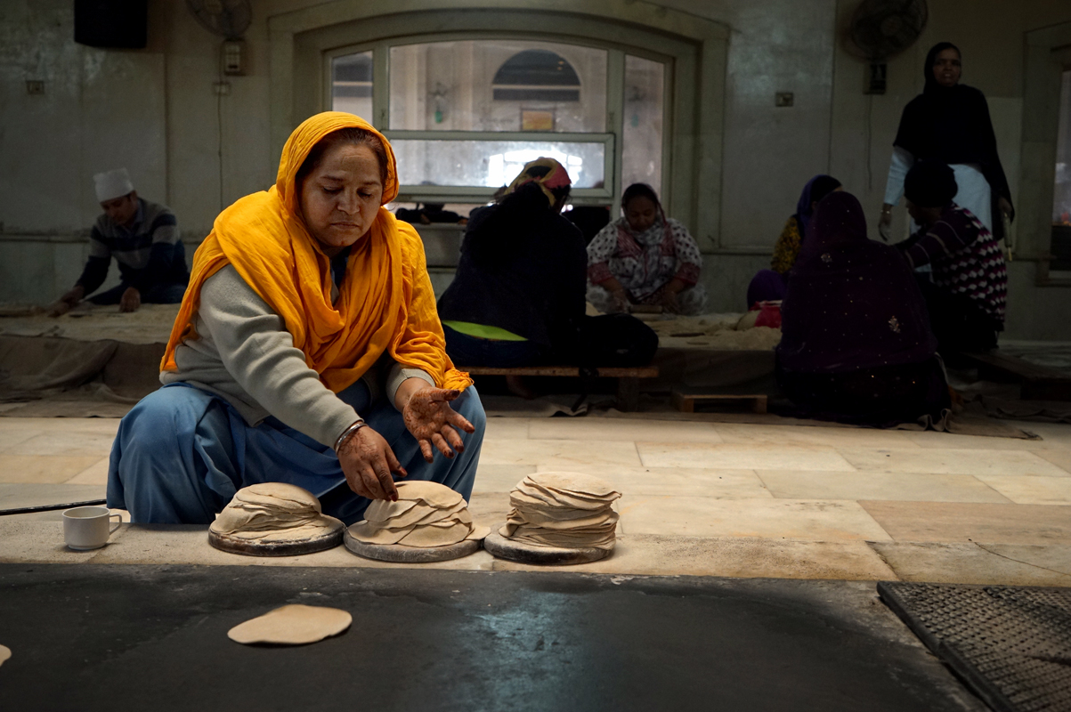 Food photography, traditional preparation, woman worker, henna hand, chapati, bread, griddle, India