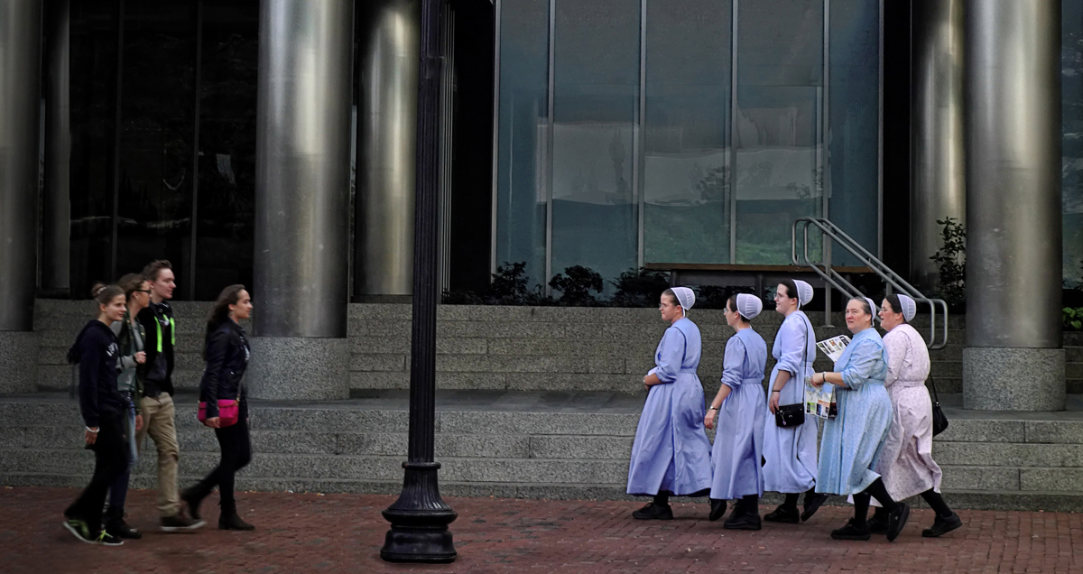 Street photography, mennonite women visit city, traditional mennonite woman dress, country visitors, South station, Boston