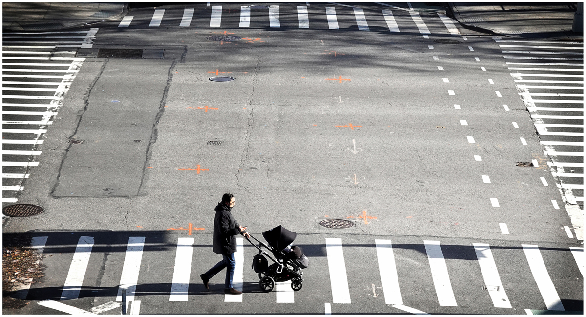 Street photography, man pushing stroller, pedestrian crossing, four-way crossing, New York City