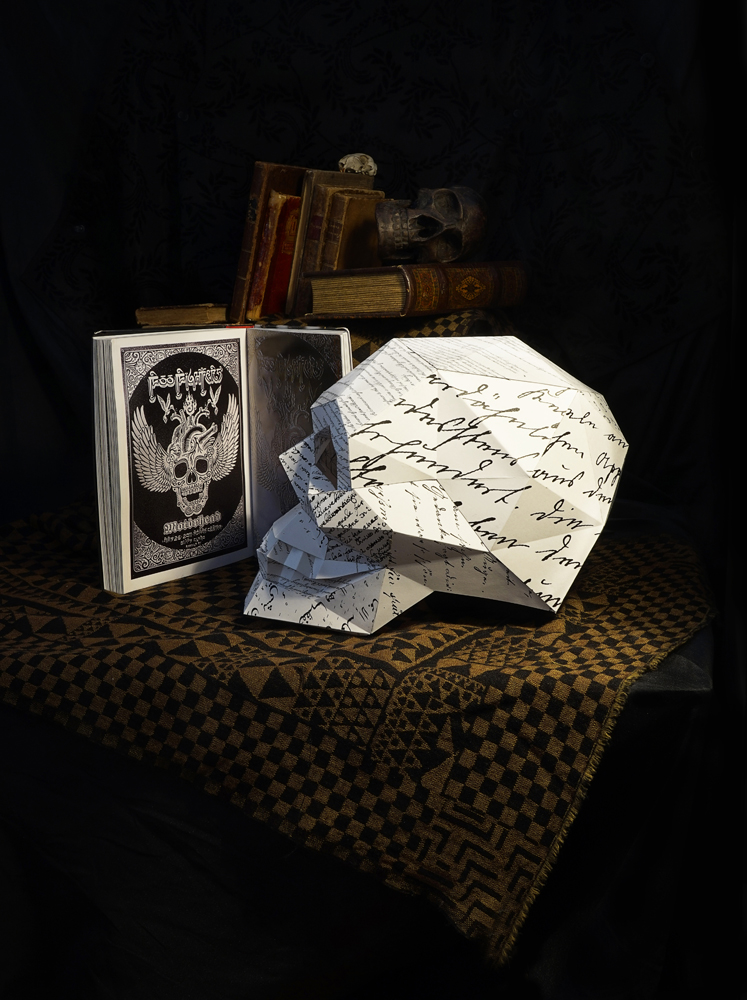Still life, paper skull ,wood skull, animal skull, book on skulls, books